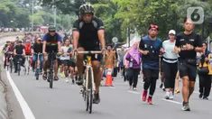 Sejumlah warga berolahraga saat Hari Bebas Kendaraan Bermotor (HBKB) di Bundaran Hotel Indonesia (HI), Jakarta, Minggu (29/12/2024). (Liputan6.com/Herman Zakharia)