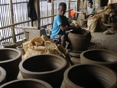 Perajin keramik tengah menyelesaikan pembuatan pot di Mekar Jaya Keramik Desa Ajun Kecamatan Plered Purwakarta, Jawa Barat, Jumat (15/9/2023). (merdeka.com/Imam Buhori)