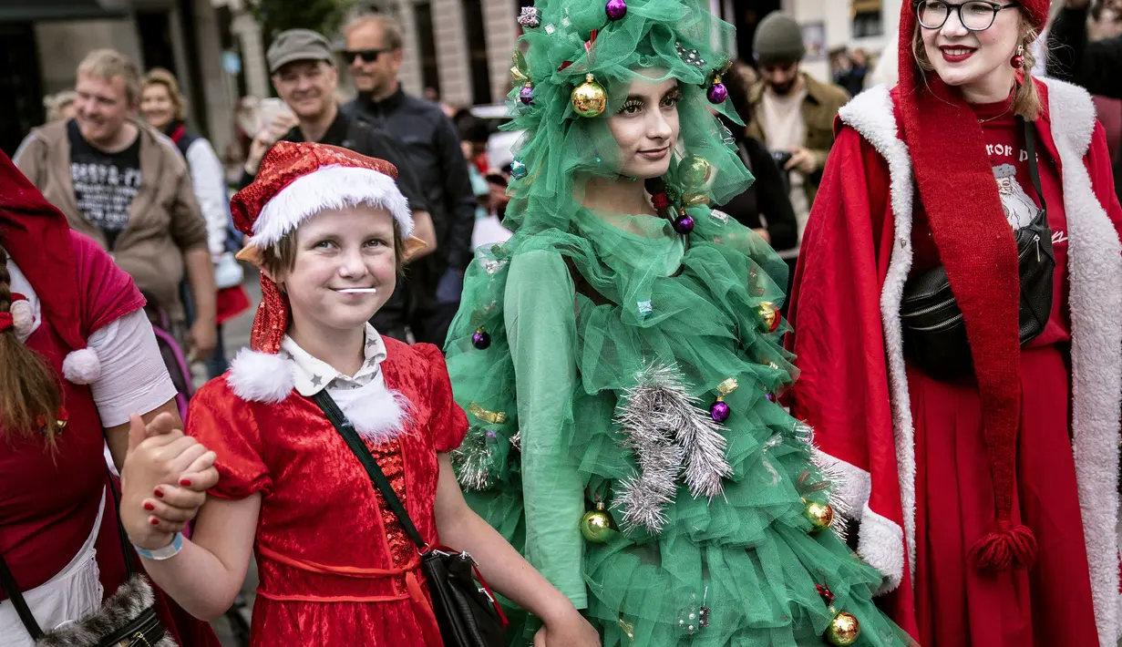 Orang-orang dari berbagai negara berpakaian seperti Sinterklas berpartisipasi dalam parade di Copenhagen, Denmark (22/7/2019). Kongres pertemuan sinterklas sudah diadakan sejak tahun1957. (Liselotte Sabroe/Ritzau Scanpix/AFP)