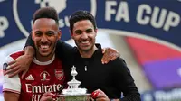 Pierre-Emerick Aubameyang bersama Mikel Arteta setelah Arsenal menjuarai Piala FA 2019/2020 di Stadion Wembley, London, Sabtu (1/8/2020). (Catherine Ivill/AFP)