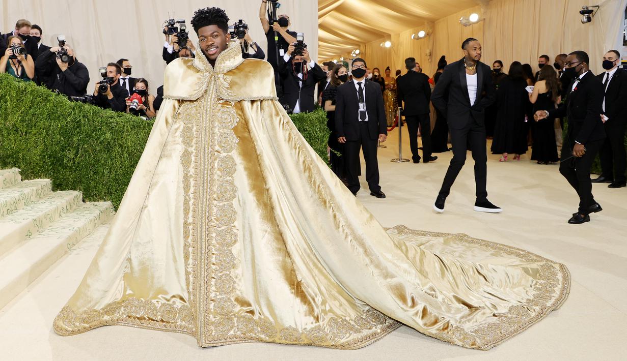 Penampilan rapper Lil Nas X menghadiri The 2021 Met Gala Celebrating In America: A Lexicon Of Fashion di Metropolitan Museum of Art, New York City, Senin (13/9/2021). Lil Nas X yang hadir di Met Gala 2021 dengan penuh totalitas tampil menggunakan 3 busana sekaligus. (Mike Coppola/Getty Images/AFP)