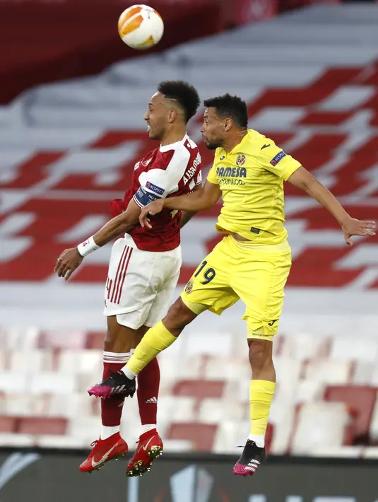 Penyerang Arsenal, Pierre-Emerick Aubameyang bersaing dengan gelandang Villareal, Francis Coquelin pada leg kedua semifinal Liga Europa di Emirates Stadium, Jumat (7/5/2021) dinihari. Villarreal menyingkirkan Arsenal dan lolos ke final setelah mencatatakan skor imbang 0-0. (AP Photo/Alastair Grant)