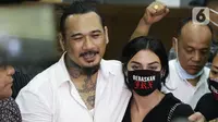 I Gede Ari Astina alias Jerinx SID (kiri) bersama istrinya Nora Alexandra memberi keterangan usai sidang putusan kasus dugaan pengancaman terhadap Adam Deni di Pengadilan Negeri Jakarta Pusat, Kamis (24/2/2022). Jerinx divonis satu tahun penjara, denda Rp 25 juta. (Liputan6.com/Helmi Fithriansyah)