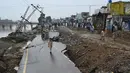 Orang-orang melihat kondisi yang rusak akibat gempa bumi melanda pinggiran Kota Mirpur di Pakistan, Rabu (25/9/2019). Jalan-jalan yang rusak serta listrik yang padam menghambat upaya-upaya penyelamatan korban gempa bermagnitudo 5,8 tersebut. (Photo by AAMIR QURESHI / AFP)