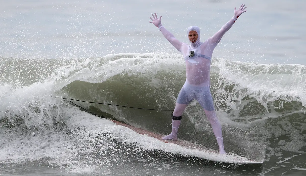 Aksi seorang peserta saat mengikuti konstes surfing Haunted Heats Halloween di Santa Monica, California, AS (29/10). Acara ini untuk merayakan hari Halloween yang jatuh pada tanggal 31 Oktober. (REUTERS/Lucy Nicholson)