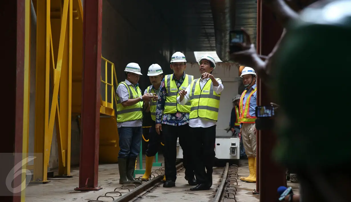 Presiden Jokowi didampingi Gubernur DKI Basuki Tjahaja Purnama (tengah) tampak melihat beberapa mesin pengeboran dan melihat cara kerja mesin bor MRT yang bernama 'Antareja' di Patung Pemuda, Senayan, Jakarta, Kamis (8/10). (Liputan6.com/Faizal Fanani)