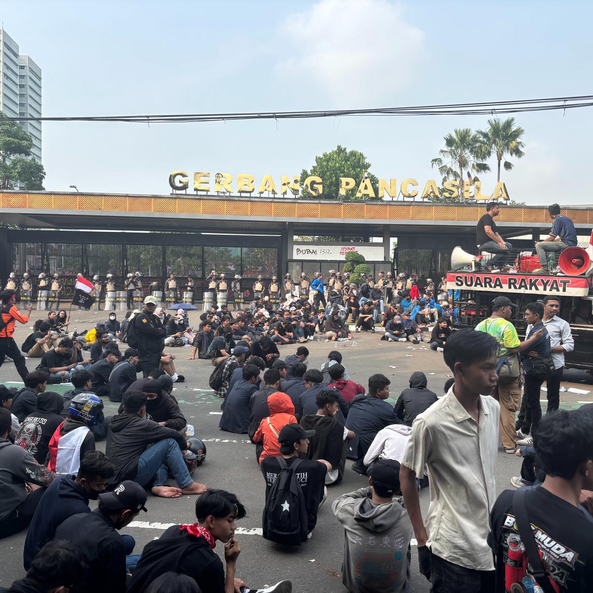 Berbaju Hitam Duduk di Tengah Jalan massa pendemo Gedung DPR