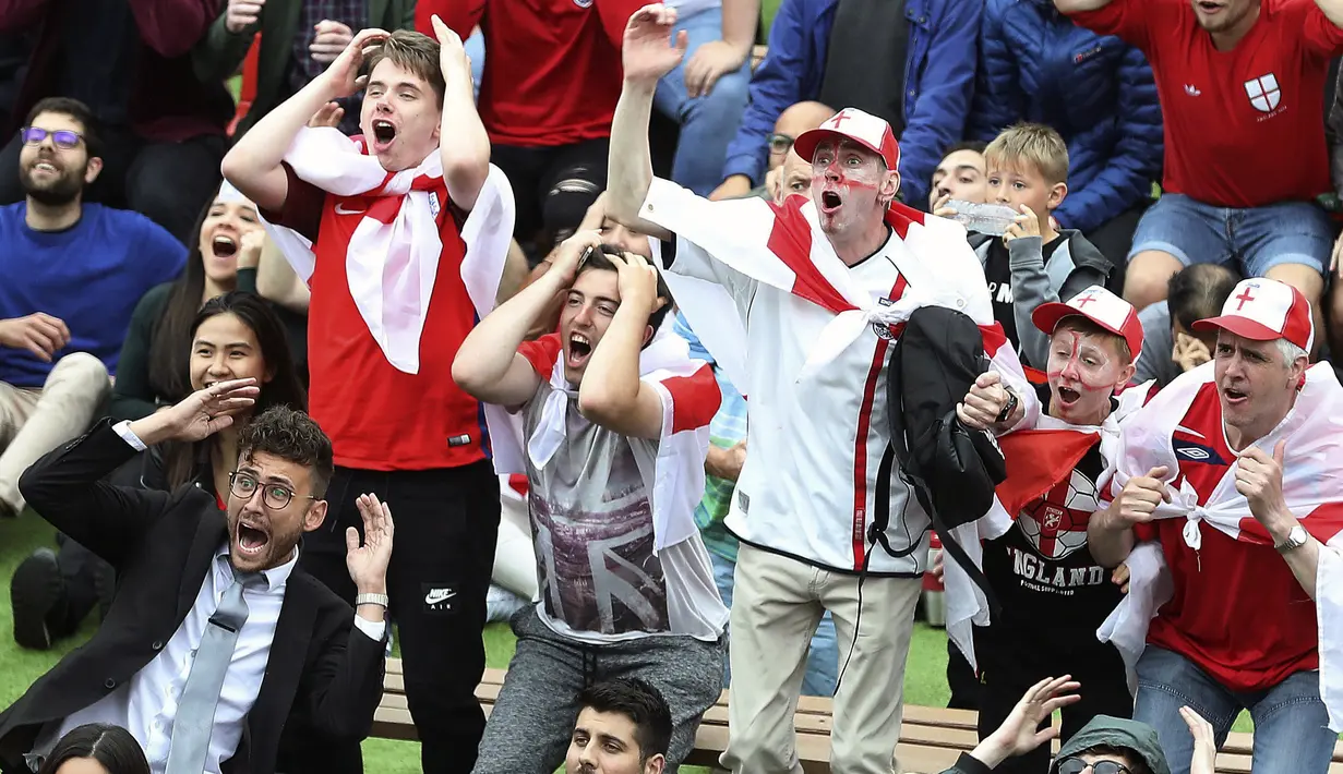 Ekspresi suporter Inggris saat menyaksikan laga timnya melawan Tunisia pada grup E Piala Dunia 2018 di Millennium Square, Leeds, Inggris, (18/6/2018). Inggris menang 2-1. (Martin Rickett/PA via AP)