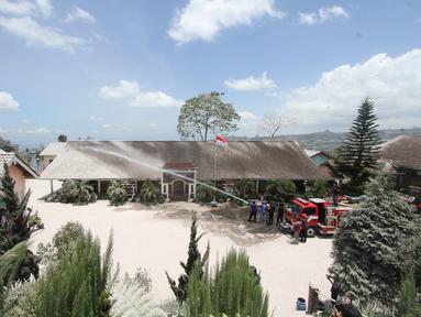 Petugas pemadam kebakaran membersihkan sekolah dari abu setelah Gunung Merapi meletus di Boyolali, Jawa Tengah pada 13 Maret 2023. Gunung Merapi yang terletak di perbatasan Jawa Tengah dan Daerah Istimewa Yogyakarta (DIY) mengeluarkan guguran awan panas pada Sabtu siang (11/3/2023). Akibat erupsi tersebut menyebabkan sejumlah daerah di Kabupaten Boyolali yang terletak di lereng Gunung Merapi diguyur hujan abu. (AFP/Dika)