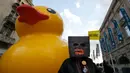 Bebek karet dibawa saat aksi mengkritik rencana tepi laut Belgrade di Beograd, Serbia, Selasa (25/4). Demo dilakukan satu tahun setelah pembongkaran misterius di daerah yang ditandai untuk proyek real estat yang didanai UEA. (AP Photo / Darko Vojinovic)