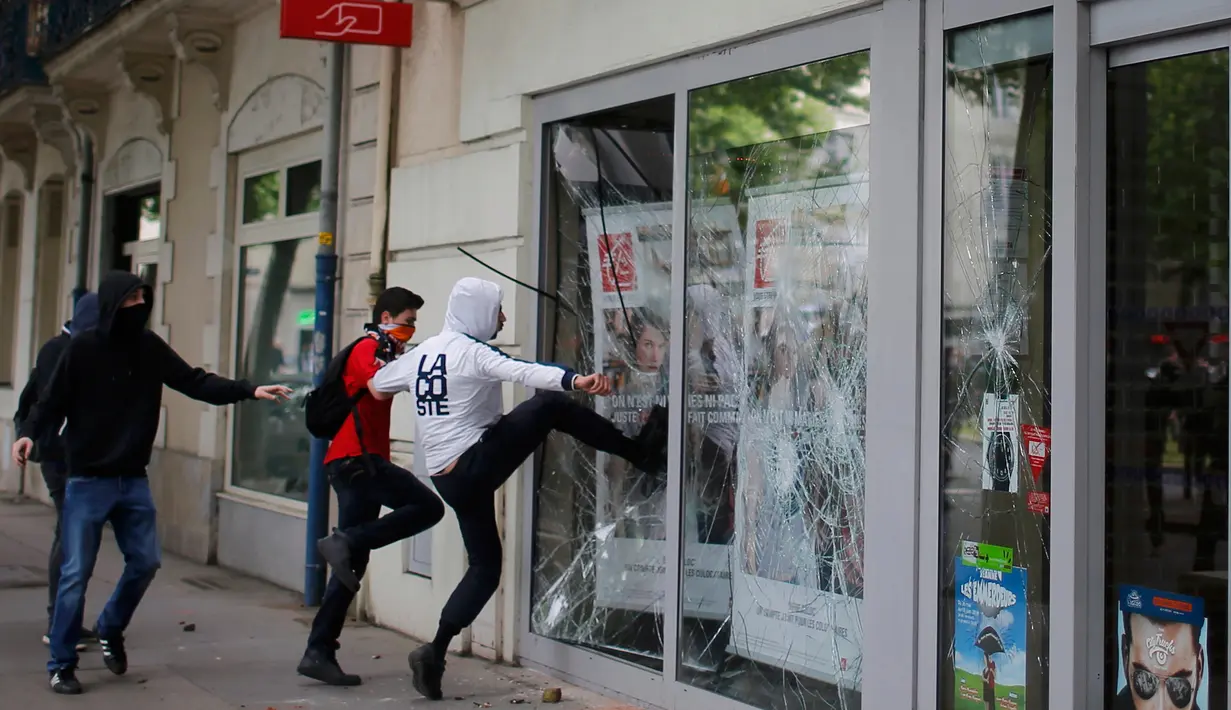 Sejumlah warga memecahkan kaca jendela sebuah bank selama unjuk rasa memprotes perubahan hukum perburuhan/ketenagakerjaan yang akan dilakukan pemerintah di Nantes, Prancis (26/5). (REUTERS / Stephane Mahe)