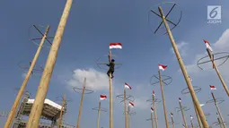 Pekerja memasang bendera Merah Putih pada pohon pinang untuk acara panjat pinang kolosal di kawasan Ancol, Jakarta, Kamis (15/8/2019). Ancol Taman Impian menggelar berbagai acara dalam menyambut HUT ke-74 RI, salah satunya adalah Panjat Pinang Kolosal. (Liputan6.com/Herman Zakharia)