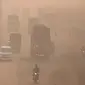 Pengendara kendaraan melintas di tengah kondisi kabut asap di Lahore, Pakistan, Senin (8/11/2021). Lahore menjadi salah satu kota paling tercemar di dunia. (Arif ALI/AFP)