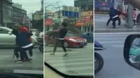 Seorang pemuda nampak membantu wanita tua menyebrang jalan dengan cara menggendongnya (Foto: shanghaiist).