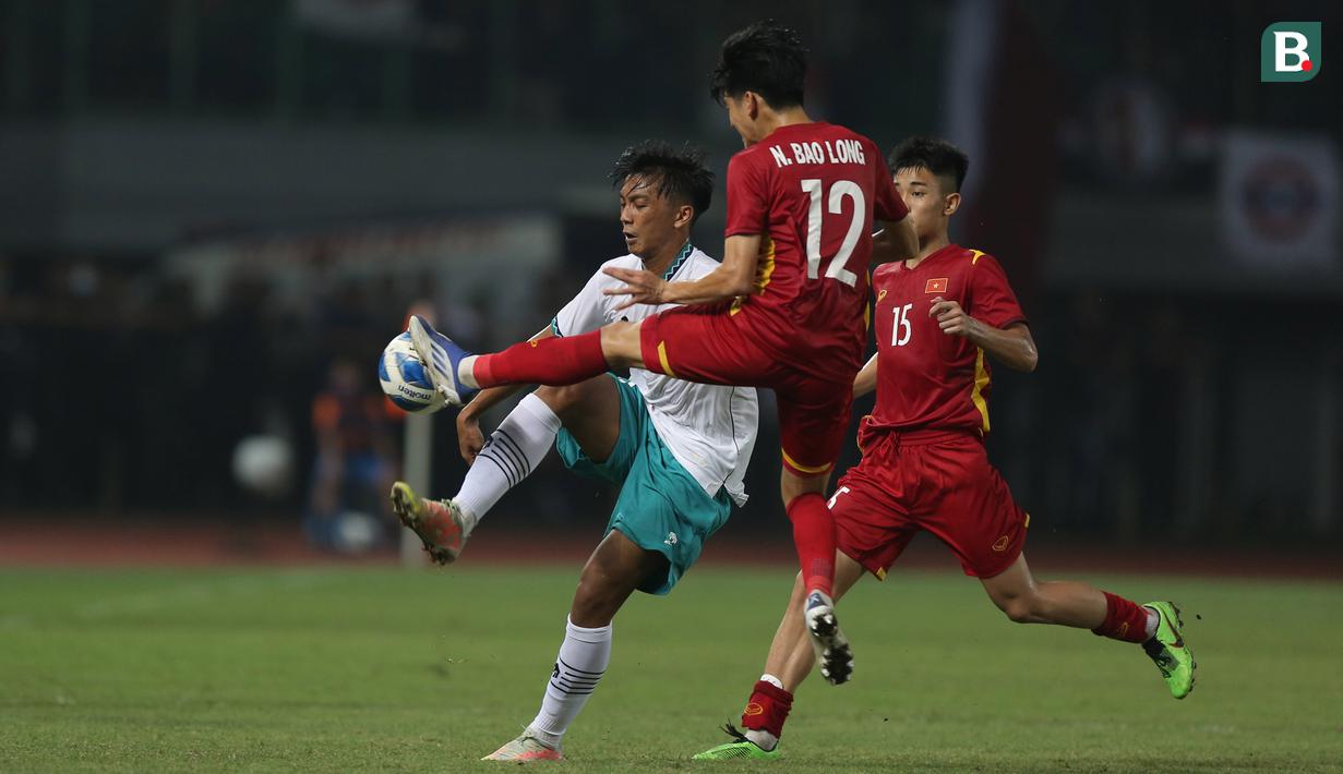 <p>Pemain Timnas Indonesia U-19, Rabbani Tasnim Siddiq (kiri) berebut bola dengan pemain Timnas Vietnam U-19, Nguyen Bao Long saat laga Grup A Piala AFF U-19 2022 antara Timnas Indonesia U-19 melawan Timnas Vietnam U-19 di Stadion Patriot Candrabhaga, Bekasi, Jawa Barat, Sabtu (02/07/2022). (Bola.com/Ikhwan Yanuar)</p>