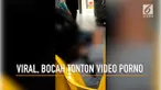 Beredar rekaman seorang bocah menonton video porno melalui sebuah handphone.
