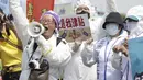 Petugas medis memegang slogan bertuliskan "Saya ingin tunjangan," saat unjuk rasa May Day di Taipei, Taiwan, Senin, 1 Mei 2023. Ribuan pengunjuk rasa dari berbagai kelompok buruh berunjuk rasa di jalan untuk meminta peningkatan kesejahteraan buruh. (AP Photo/Chiang Ying-ying)