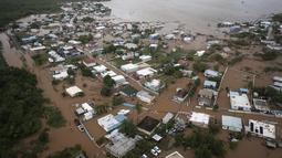 Rumah-rumah terendam banjir di Pantai Salinas setelah lewatnya Badai Fiona di Salinas, Puerto Rico, Senin, 19 September 2022. Badai Fiona yang menerjang Puerto Rico menyebabkan banjir dan tanah longsor. (AP Photo/Alejandro Granadillo)