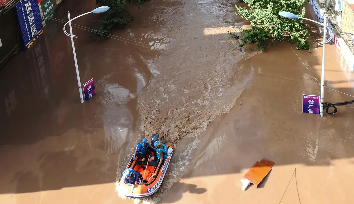 Tim SAR saat mencari penduduk yang terkena dampak banjir setelah hujan lebat di Dazhou, Sichuan, China, Minggu (11/7/2021). Banjir akibat hujan lebat melanda sejumlah wilayah di China. (AFP/STR)