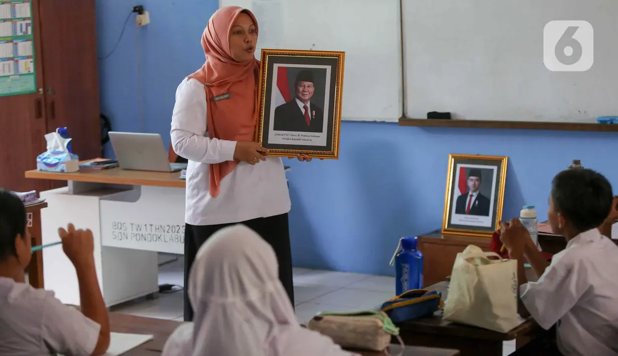 Salah satu guru memberikan penjelasan kepada murid SDN Pondok Labu 14 terkait pergantian Presiden dan Wakil Presiden. (Liputan6.com/Herman Zakharia)