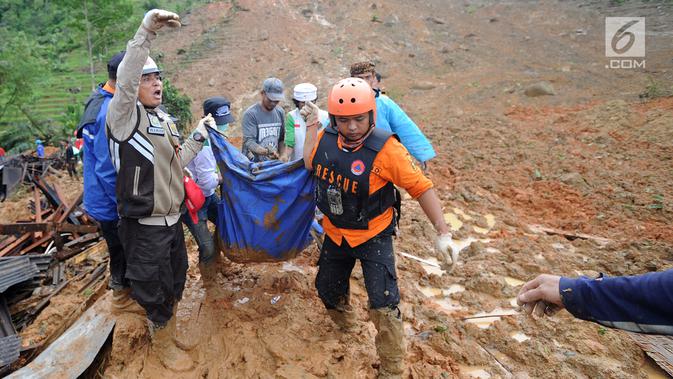 Tim SAR dibantu warga sekitar mengevakuasi jenazah korban longsor di Dusun Cimapag, Desa Sirnaresmi, Kecamatan Cisolok, Sukabumi, Selasa (1/1). Longsor menerjang satu dusun menjelang malam tahun baru pada pukul 17.00 WIB. (merdeka.com/Arie Basuki)