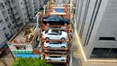Sejumlah mobil parkir di parkiran bertingkat tiga dimensi di Shenyang, provinsi Liaoning, China  (19/6). Tempat parkir ini terbuat dari konstruksi besi yang dapat menampung hampir 40 mobil. (AFP Photo/Str/China Out)