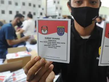 Petugas memperlihatkan surat suara di Gudang Logistik KPU, Depok, Senin (23/11/2020). Komisi Pemilihan Umum (KPU) Kota Depok telah menerima sebanyak 1.262.051 surat suara yang dicetak untuk Pilkada 2020 sesuai jumlah daftar pemilih tetap (dpt) ditambah 2,5 persen cadangan. (merdeka.com/Arie Basuki)