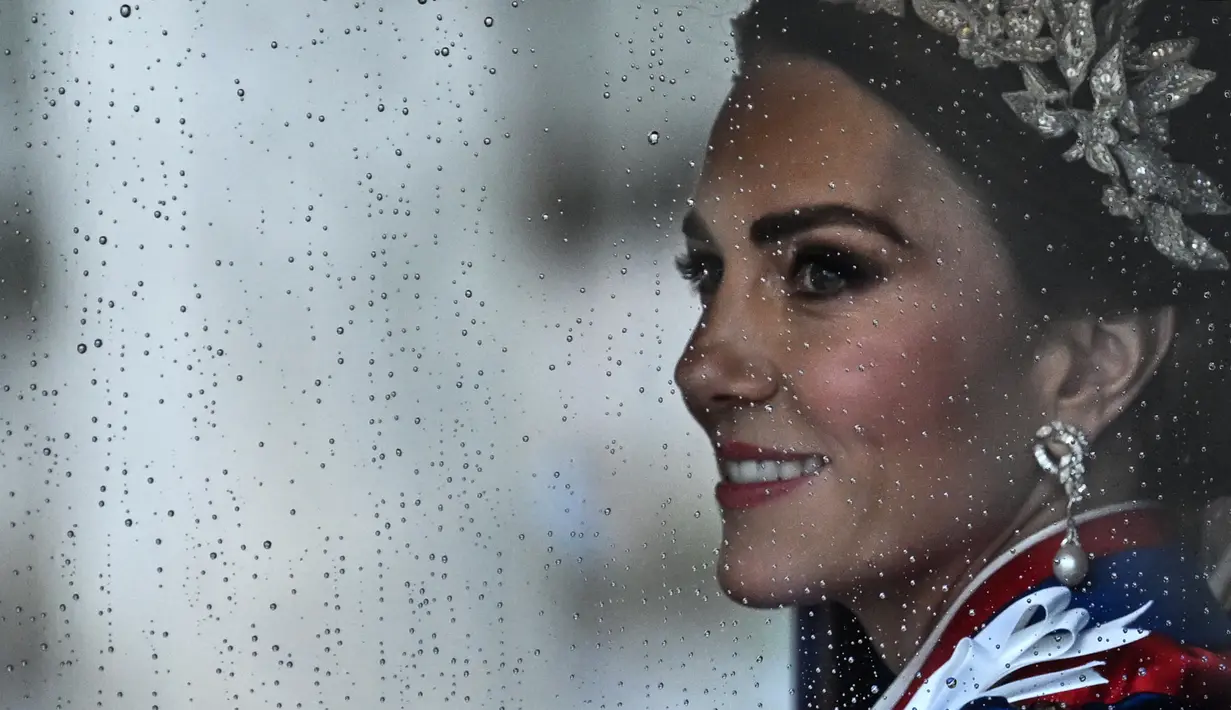 Setelah seremoni selesai, Kate Middleton ikut dalam pawai iring-iringan kereta kuda dari Westminster Abbey yang menuju Istana Buckingham. (Photo by Paul ELLIS / AFP)