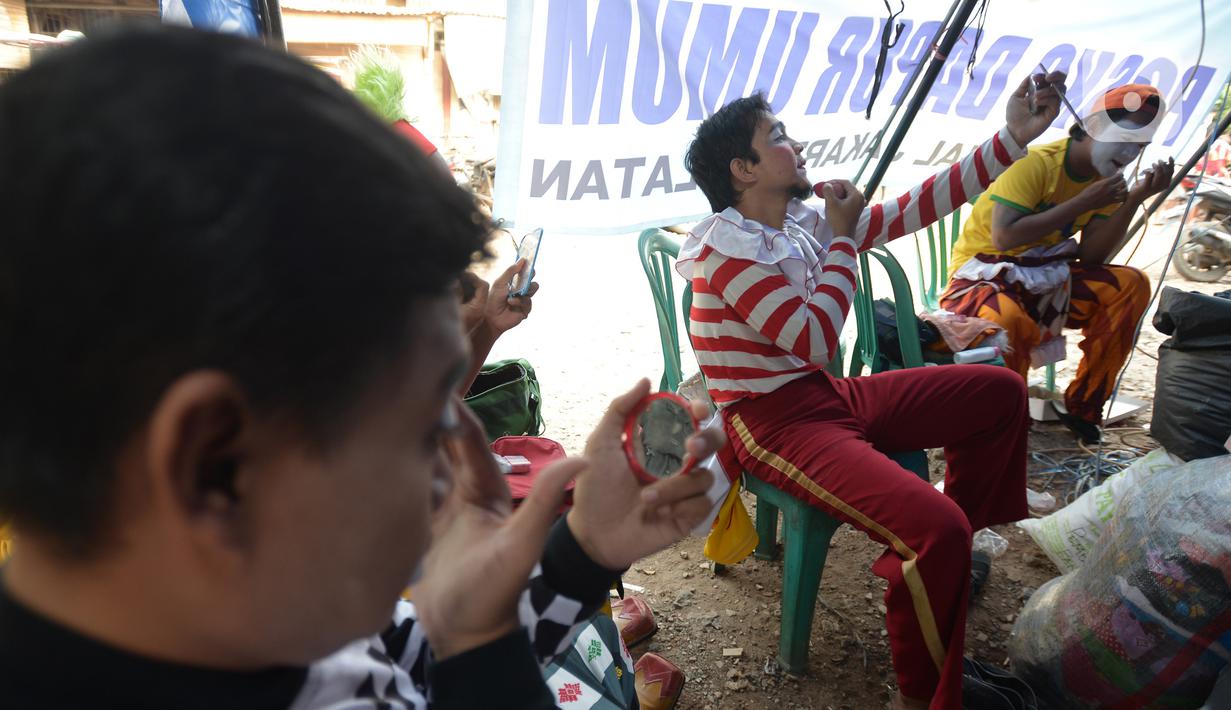 Badut komunitas Aku Badut Indonesia bersiap menghibur anak-anak di pengungsian korban kebakaran di Jalan Kemang Utara IX, Jakarta Selatan, Rabu (18/8/2021). Dengan memberi hiburan, diharap anak-anak dapat melupakan kesedihan dan keresahan yang mereka alami pascakebakaran. (merdeka.com/Imam Buhori)