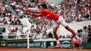 Petenis Serbia, Novak Djokovic memukul bola ke arah lawannya petenis Swiss, Henri Laaksonen pada putaran kedua Prancis Terbuka 2019 di Stadion Rolland Garros, Kamis (30/5/2019). Djokovic untuk ke-14 kalinya melaju ke babak ketiga Prancis Terbuka usai menang 6-1, 6-4 6-3. (REUTERS/Kai Pfaffenbach)