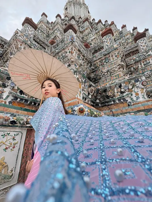 <p>Jika ke Bangkok, tentu saja Wat Arun tidak boleh dilewatkan. Kiky Saputri dengan anggun berfoto mengenakan busana tradisional. (Foto: Instagram/ kikysaputrii)</p>