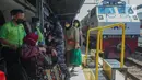 Petugas membantu penumpang berkursi roda sambil menunggu kedatangan kereta api tujuan di Stasiun Senen, Jakarta, Jumat (8/7/2022). Dua hari menjelang Idul adha 2022, jumlah penumpang kereta api jarak jauh meningkat dua kali lipat di Stasiun Pasar Senen dengan jumlah 14.470 penumpang dari 24 jadwal keberangkatan KA. (Liputan6.com/Herman Zakharia)