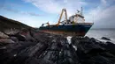 Kapal kargo sepanjang 77 meter, MV Alta,  terjebak di atas batu di dekat Ballycotton, Cork, Irlandia, Selasa (18/2/2020). "Kapal hantu" yang berlayar tanpa awak selama lebih dari satu tahun hanyut dan terbawa ke pantai selatan Irlandia menyusul sapuan Badai Dennis. (Cathal Noonan/AFP)