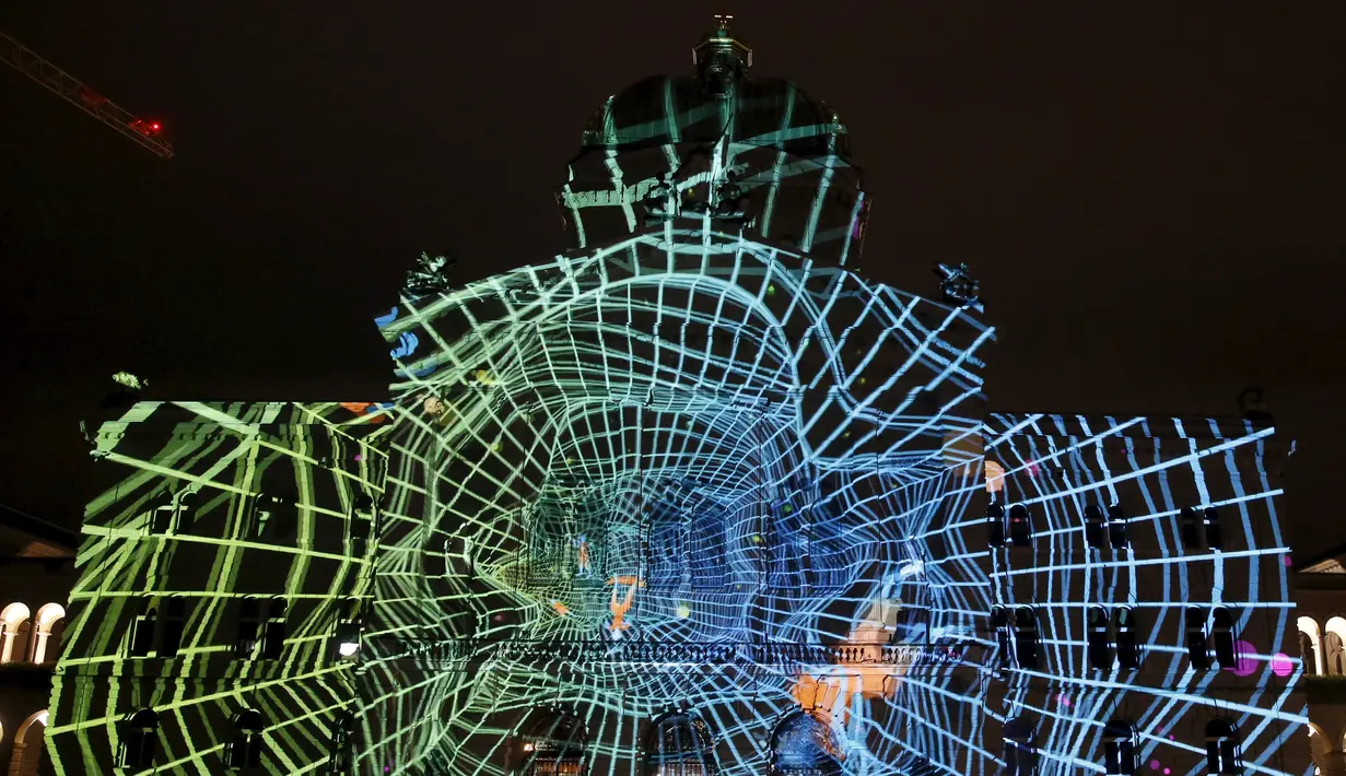 Gedung Parlemen Swiss diterangi cahaya - cahaya unik hasil proyeksi raksasa atau "The Jewel of the Mountains " di Bern, Swiss, Kamis (15/10/2015).  Gedung ini akan diterangi cahay proyeksi setiap malamnya hingga 29 November 2015. (REUTERS/Ruben Sprich)