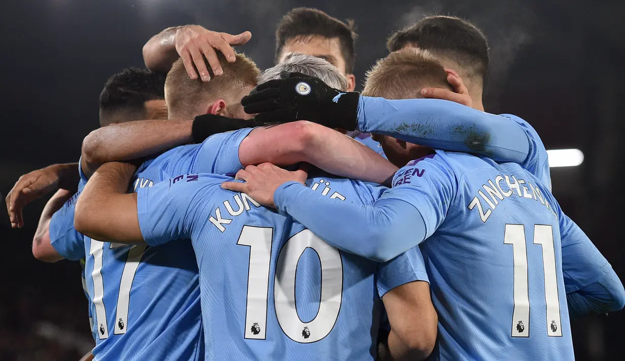Striker Manchester City, Sergio Aguero (tengah) bersama rekan setimnya mereyakan gol ke gawang Sheffield United  pada pekan ke-24 Liga Inggris di Bramall Lane, Selasa (21/1/2020). Aguero mencetak gol semata wayang untuk kemenangan Man City saat berkunjung ke markas Sheffield United. (OLI SCARFF/AFP)
