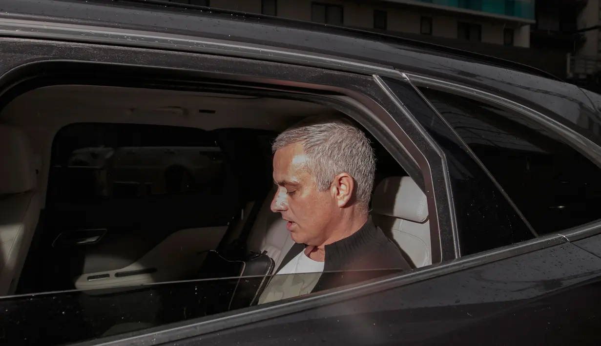 Mantan pelatih Manchester United, Jose Mourinho berada di mobil untuk meninggalkan Lowry Hotel di Manchester, Inggris, (18/12). Mourinho dipecat setelah dua setangah musim melatih Manchester United. (AP Photo / Jon Super)