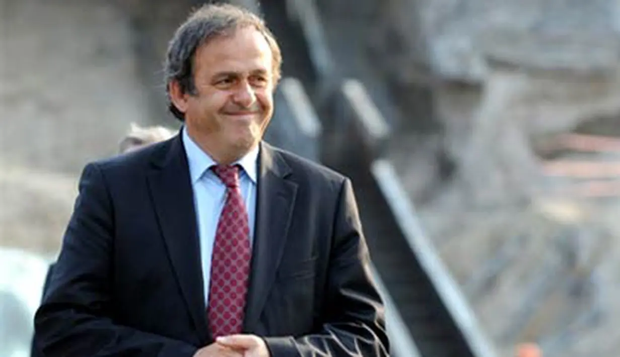 UEFA president Michel Platini smiles as he examines a construction site during a visit on rebuilding Kiev's stadium Olympiysky on April 15, 2009. AFP PHOTO/ SERGEI SUPINSKY 