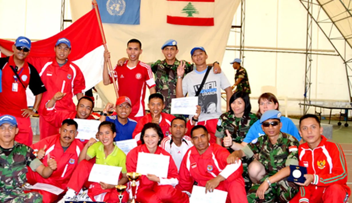 Citizen6, Lebanon: Foto bersama Atlet dan Oficial tim pebulutangkis Indobatt dengan Wakil Komandan Indobatt, setelah merayakan kemenangan keluar sebagai juara umum, bertempat di Rubb Hall, Markas UNIFIL, Lebanon, Senin (25/6). (Pengirim: Badarudin Bakri).