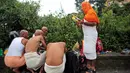 Umat Hindu Nepal melakukan ritual dibimbing oleh pemuka agama di kuil Hindu Gokarneshwar, Kathmandu, Nepal (21/8). Anak laki-laki dan perempuan yang ayahnya masih hidup, wajib menghabiskan waktu bersama dengan membawa hadiah. (Niranjan Shrestha/AP)