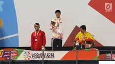 Atlet Indonesia Aris Wibawa saat penyerahan mendali dalam babak final putra 100 meter gaya dada SB7 para renang Asian Para Games 2018 di Aquatic Center, GBK, Jakarta, Senin (8/10). Aris berhasil meraih perak dalam kelas tersebut. (Merdeka.com/Imam Buhori)