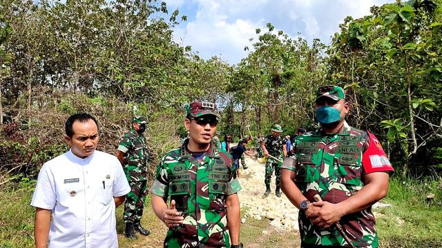 Komandan Korem 073/Makutarama, Kolonel Inf Purnomosidi (tengah) bersama Komandan Kodim 0721/Blora, Letkol Inf Andy Soelistyo Kurniawan Putro (kanan) dan Kepala Desa Pengkoljagong, Sugiyono (kiri) saat diwawancarai awak media di lokasi TMMD ke-113 tepatnya di jalan hutan menuju Dukuh Alas Malang. (Liputan6.com/Ahmad Adirin)