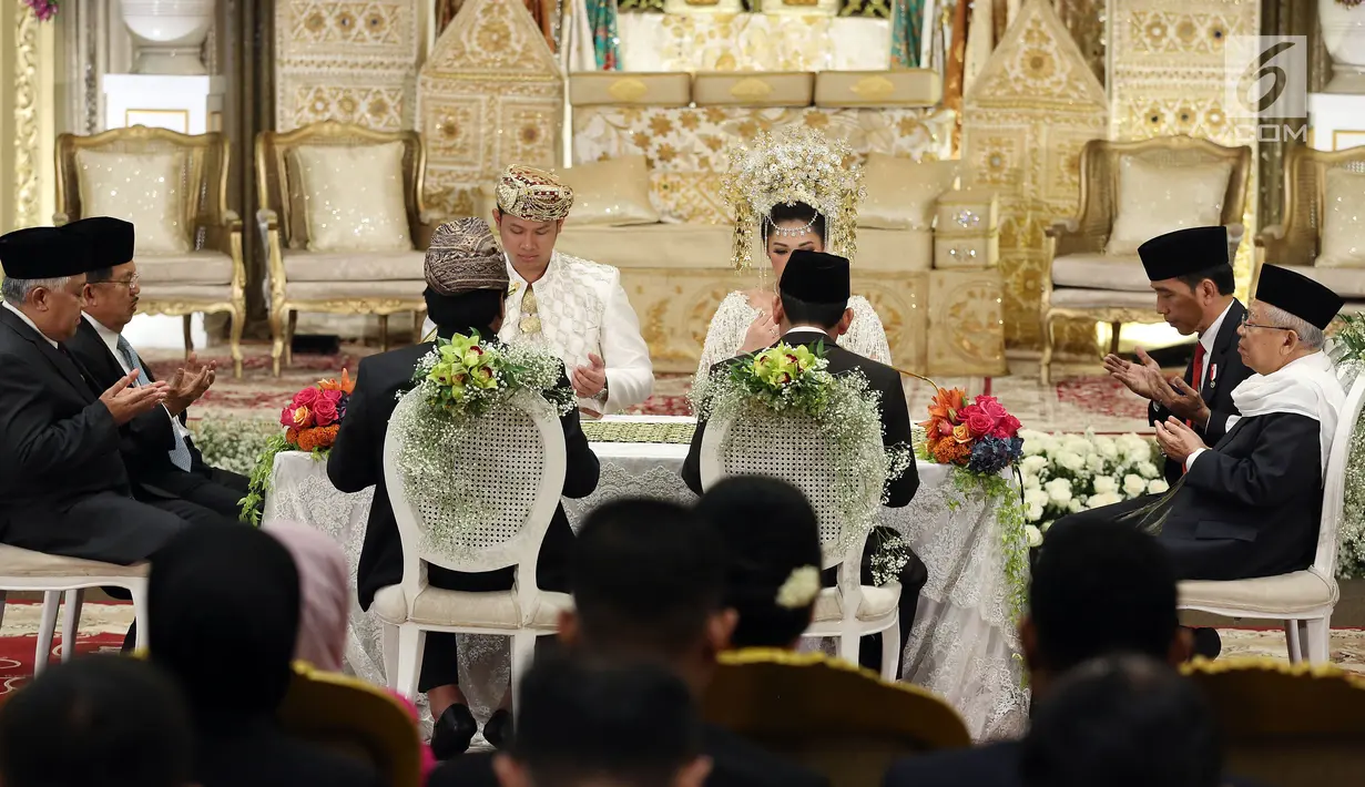 Presiden Joko Widodo (Jokowi) dan Wapres Jusuf Kalla hadir dalam akad nikah putri Ketua DPD, Oesman Sapta Odang di kawasan Kuningan, Jakarta, Jumat (8/9). Keduanya menjadi saksi pernikahan anak bungsu OSO, Putri Selaras Oesman. (Liputan6.com/Johan Tallo)