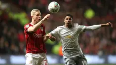 Pemain Bristol City, Hordur Bjorgvin Magnusson berebut bola dengan pemain Manchester United, Marcus Rashford pada perempat final Piala Liga Inggris di Ashton Gate, Kamis (21/12). MU gagal ke babak empat besar setelah kalah 1-2. (Nick Potts/PA via AP)