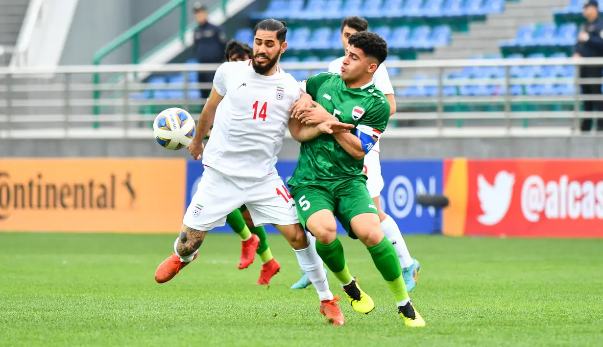 Pemain Iran U-20, Erfan Ghorbani (kiri) berebut bola dengan pemain Irak U-20, Abdulrazzak Qasim Subaihawi pada laga perempatfinal Piala Asia U-20 2023 di JAR Stadium, Tashkent, Uzbekistan, Sabtu (11/3/2023). (AFC/Adam Aidil)