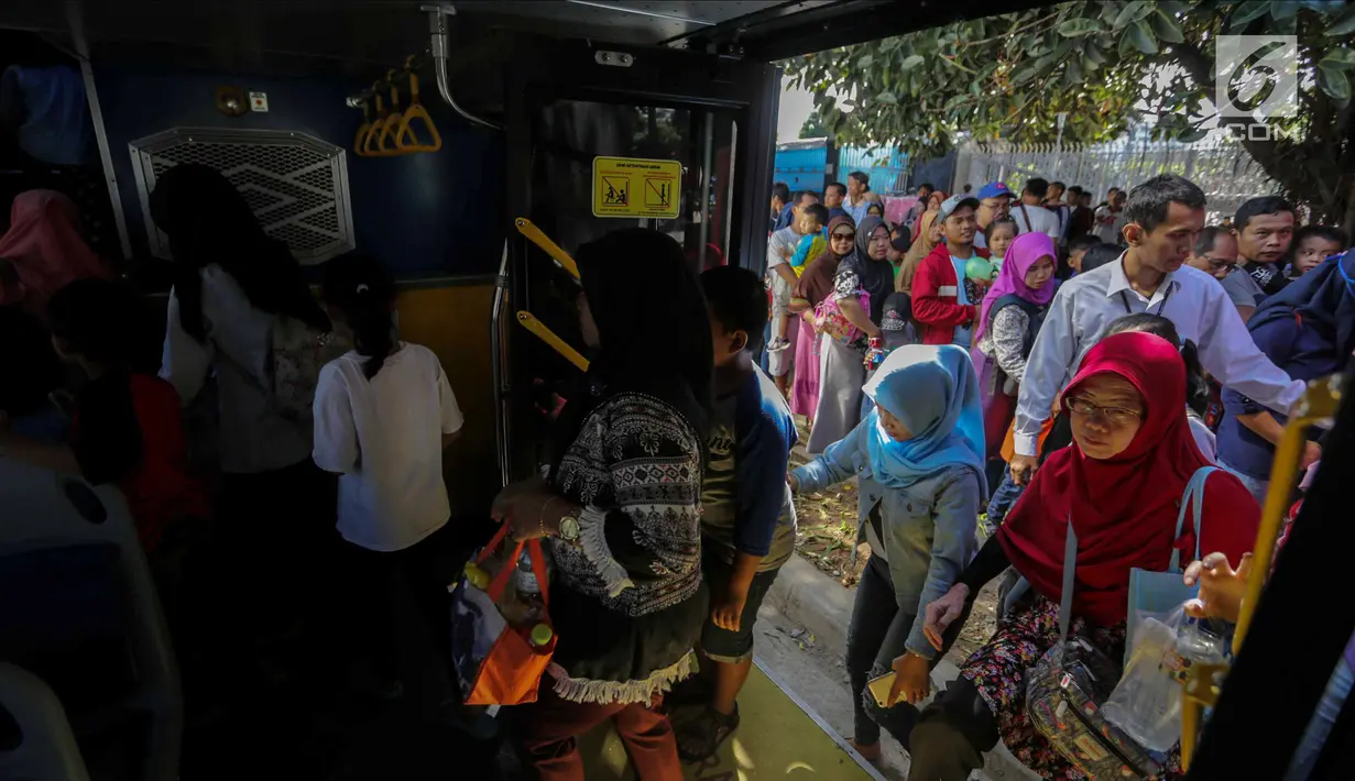Sejumlah warga menaiki bus City Tour di kawasan Masjid Istiqlal, Jakarta, Senin (25/12). Bus tingkat wisata keliling Jakarta ini banyak diminati warga Jakarta dan sekitarnya untuk mengisi liburan. (Liputan6.com/Faizal Fanani)