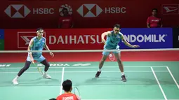 Pemain ganda putra Indonesia, Fajar Alfian (kanan) yang berpasangan dengan Muhammad Rian Ardianto berusaha mengembalikan bola saat menghadapi sesama pasangan Indonesia, Leo Rolly Carnando/Daniel Marthin pada laga semifinal Daihatsu Indonesia Masters 2024 di di Istora Senayan, Jakarta, Sabtu (27/1/2024). Fajar/Rian kalah rubber game dengan skor 21-19, 14-21 dan 17-21. (Bola.com/Pradipta Rama)