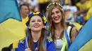 Dua Suporter cantik Ukraina terlihat bersemangat mendukung timnya berlaga melawan Polandia pada Euro 2016 di Stadion Velodrome, Marseille, Rabu (22/6/2016) dini hari WIB. (AFP/Bertrand Langlois)