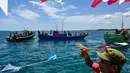 Indonesian fishermen take part in the traditional festival known as "Kenduri Laot," a maritime feast held as an expression of gratitude for the ocean, off the coast of Banda Aceh on July 22, 2026. (Photo by CHAIDEER MAHYUDDIN / AFP)
