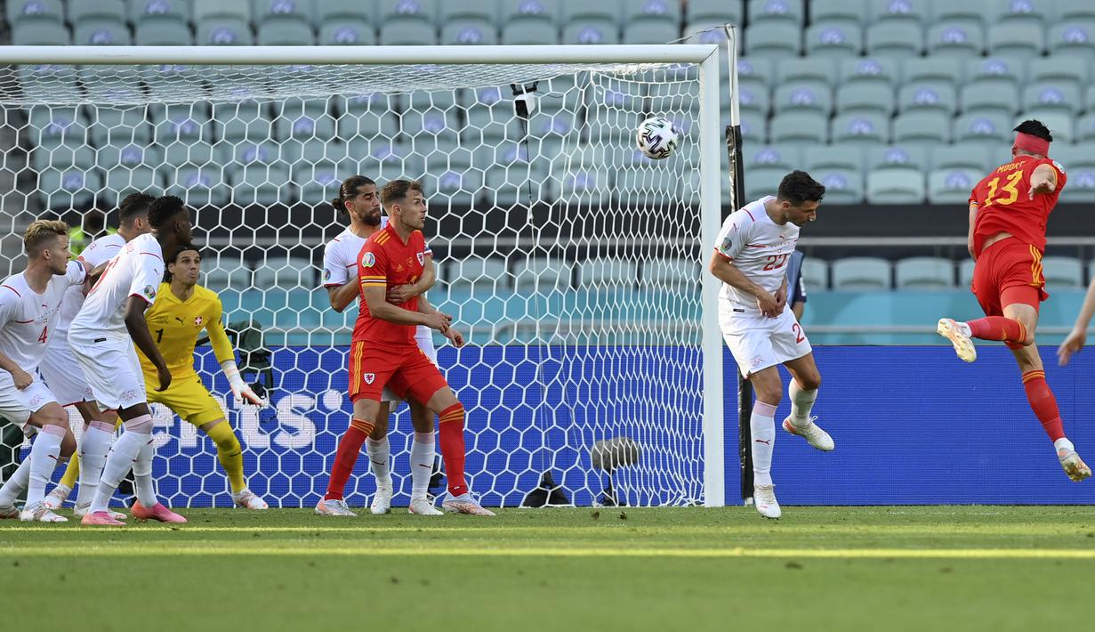 Wales baru berhasil menyamakan kedudukan pada menit ke-74 lewat tandukan gelandang Kieffer Moore (kanan) memanfaatkan umpan dari Joe Morrell. Skor berubah 1-1. (Foto: AP/Darko Vojinovic/Pool)