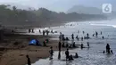 Wisatawan beraktifitas di pinggir pantai di kawasan Pantai Karang Naya, Pelabuhan Ratu, Sukabumi, Selasa (1/6/2021). Walaupun liburan lebaran telah usai sejumlah pantai di kawasan Pelabuhan Ratu masih dipadati pengunjung yang berasal dari Kota Jakarta dan Jawa Barat.(merdeka.com/Arie Basuki)